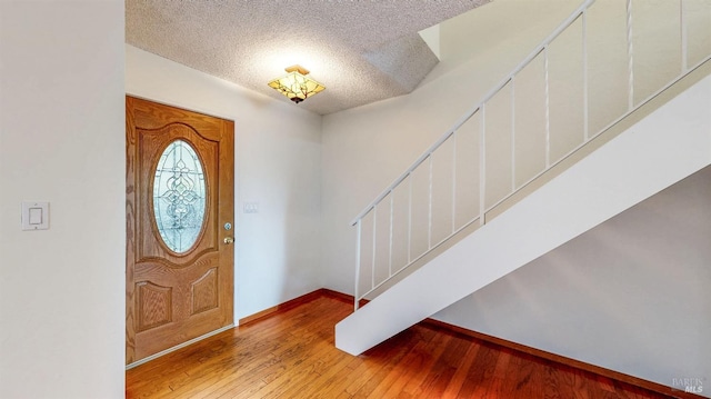 117 Sunset Cir Unit 36, Benicia, CA 94510 - entryway featuring a textured ceiling, wood-type flooring, stairway, and baseboards