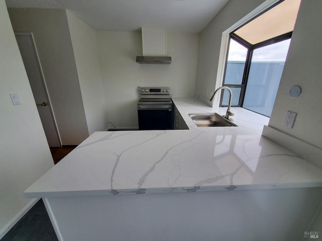 kitchen with exhaust hood, light stone countertops, a sink, stainless steel electric range oven, and wall chimney exhaust hood