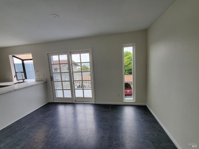 interior space with a sink and baseboards