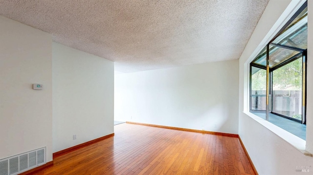 117 Sunset Cir Unit 36, Benicia, CA 94510 - spare room with hardwood / wood-style floors, a textured ceiling, and baseboards