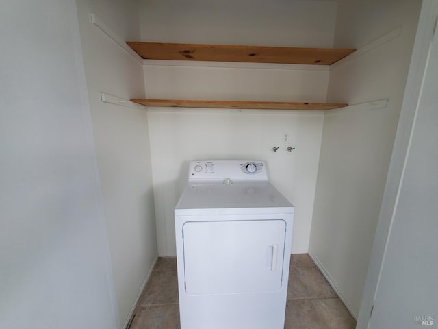 laundry room featuring light tile patterned floors, washer / clothes dryer, and laundry area