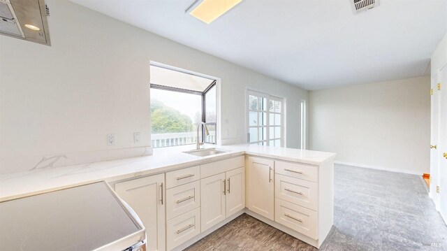 117 Sunset Cir Unit 36, Benicia, CA 94510 - kitchen featuring a sink, white range with electric stovetop, a peninsula, and white cabinetry