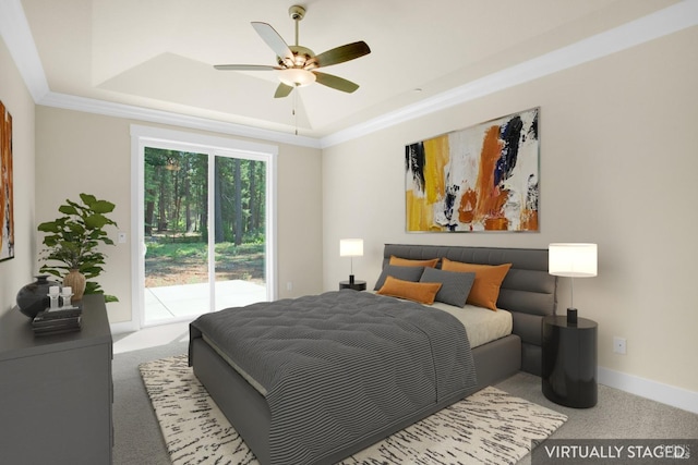carpeted bedroom featuring access to outside, ornamental molding, baseboards, a ceiling fan, and a tray ceiling