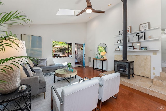 11969 Canyon Dr, Guerneville, CA 95446 - living area featuring a wood stove, a ceiling fan, high vaulted ceiling, a skylight, and wood finished floors