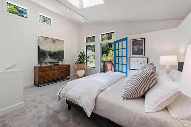 11969 Canyon Dr, Guerneville, CA 95446 - bedroom with track lighting, a skylight, carpet flooring, access to exterior, and baseboards