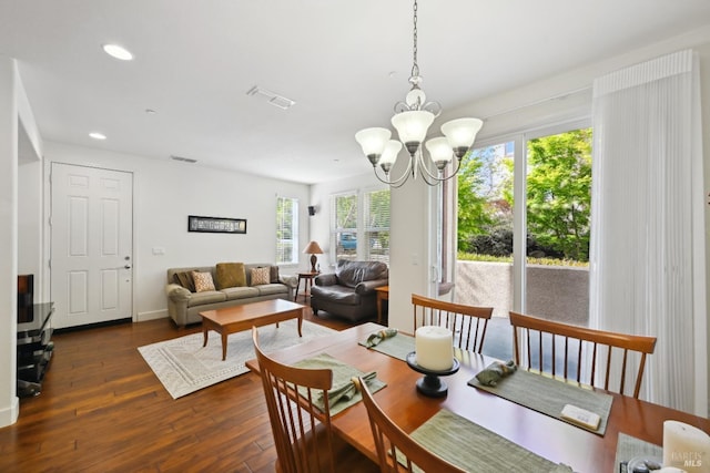 dining area with visible vents, hardwood / wood-style flooring, an inviting chandelier, and recessed lighting