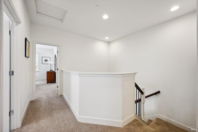 hallway with recessed lighting, an upstairs landing, light carpet, and baseboards