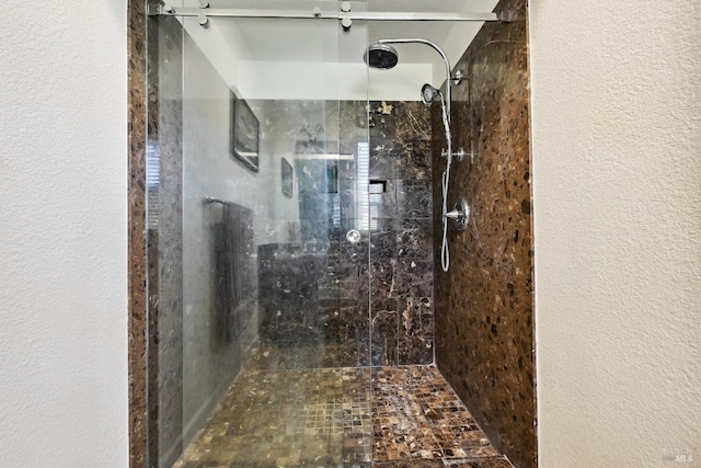 bathroom featuring a stall shower and a textured wall