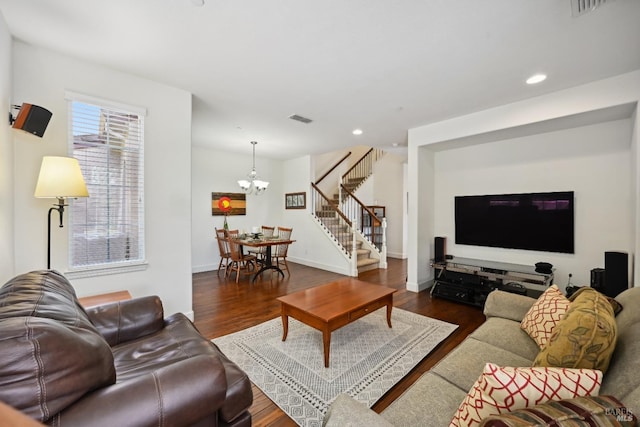 living area featuring visible vents, recessed lighting, a notable chandelier, and stairs