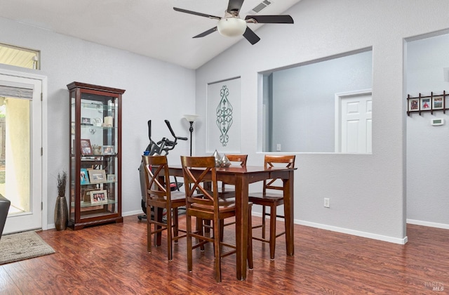 dining area featuring lofted ceiling, ceiling fan, visible vents, baseboards, and wood finished floors