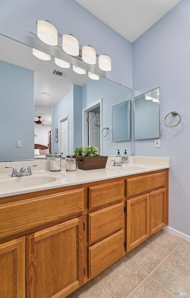 full bathroom with tile patterned floors, visible vents, double vanity, and a sink