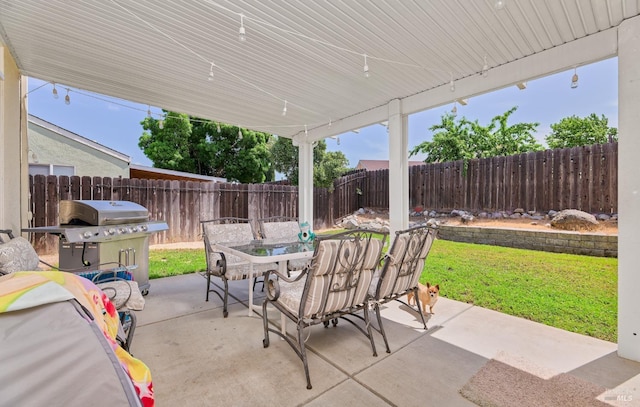 view of patio / terrace featuring outdoor dining space, grilling area, and a fenced backyard
