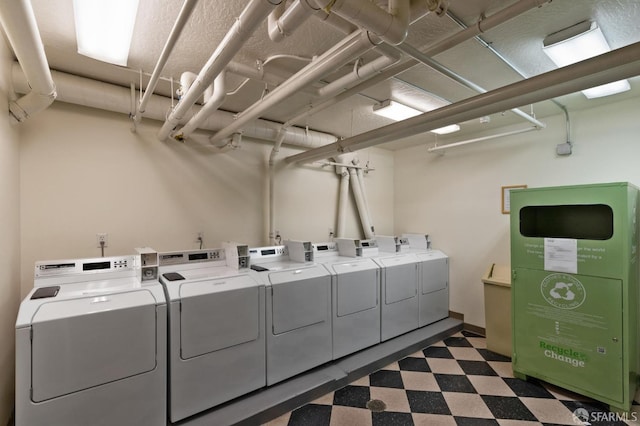 1483 Sutter St Unit 901, San Francisco, CA 94109 - shared laundry featuring washing machine and clothes dryer and dark floors