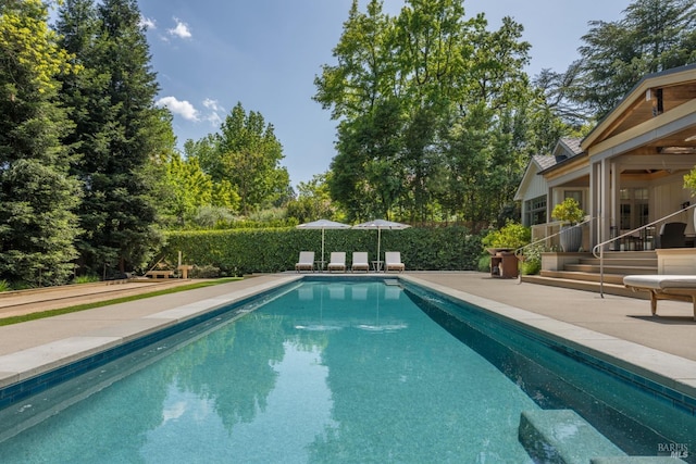 view of swimming pool featuring a fenced in pool and a patio area