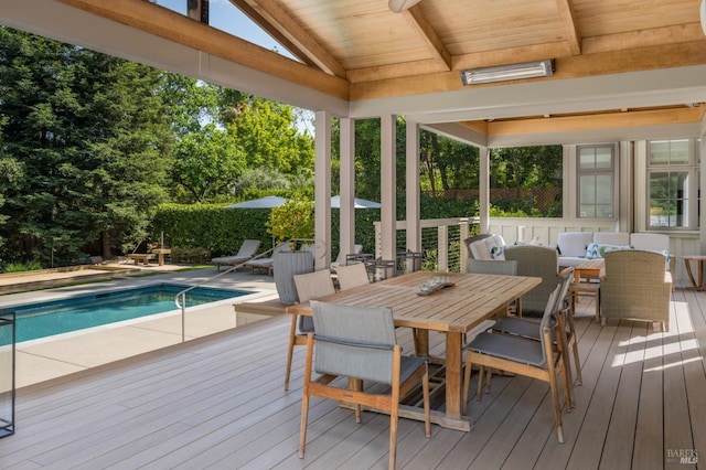 sunroom / solarium featuring an outdoor living space, outdoor dining area, and beam ceiling