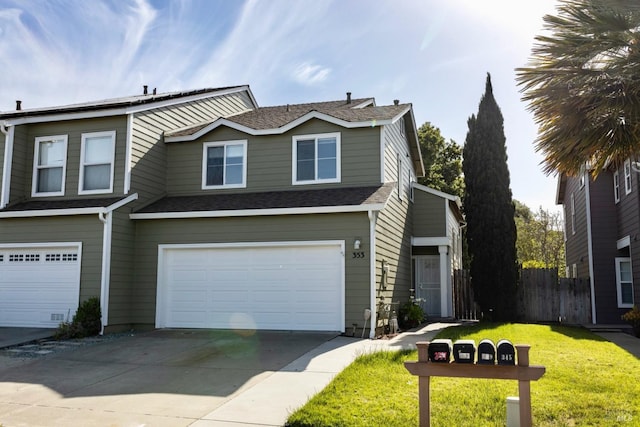 view of front of property with fence, a garage, driveway, roof with shingles, and a front yard