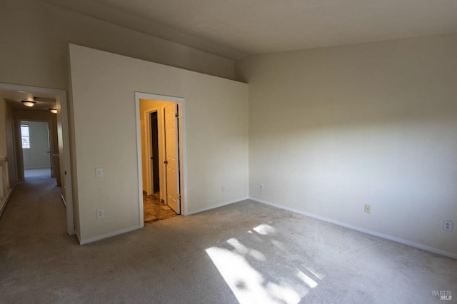 unfurnished bedroom with baseboards and carpet