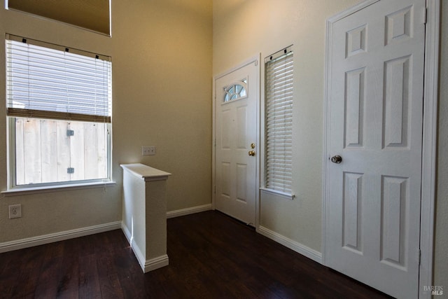 entryway featuring dark wood-style flooring and baseboards