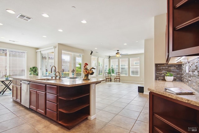 kitchen featuring tasteful backsplash, stainless steel dishwasher, open shelves, a sink, and light tile patterned flooring