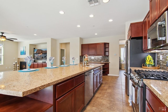 kitchen featuring tasteful backsplash, open shelves, appliances with stainless steel finishes, a sink, and visible vents