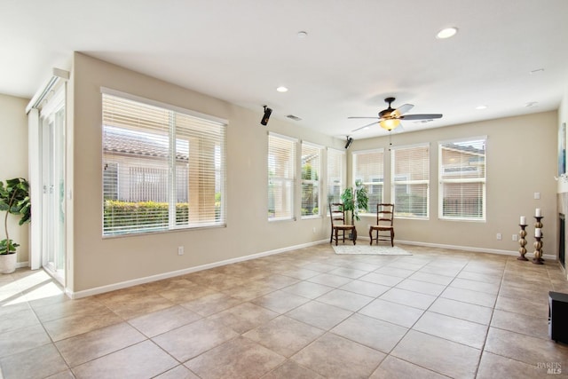 interior space featuring light tile patterned floors, a ceiling fan, recessed lighting, and baseboards
