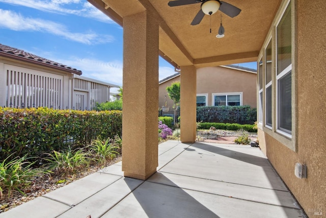 view of patio with a ceiling fan and fence