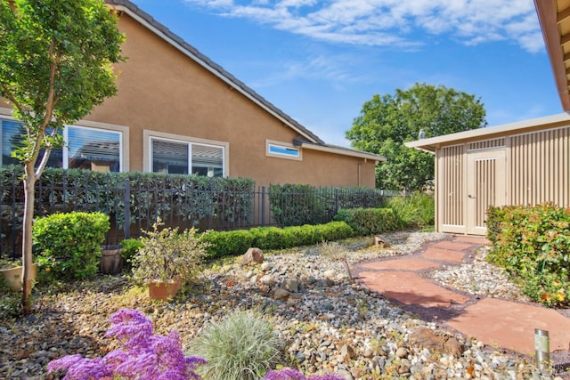 view of property exterior featuring fence and stucco siding