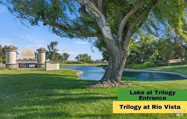 surrounding community with a water view and a lawn