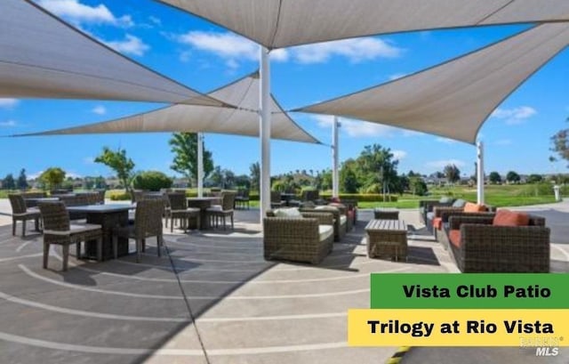 view of community featuring an outdoor living space and outdoor dining area
