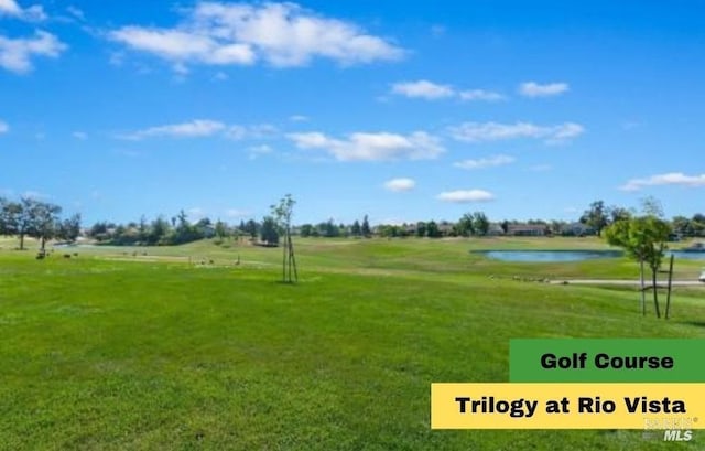 view of property's community with a lawn and a water view