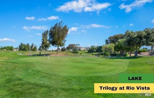 view of home's community featuring a yard and view of golf course