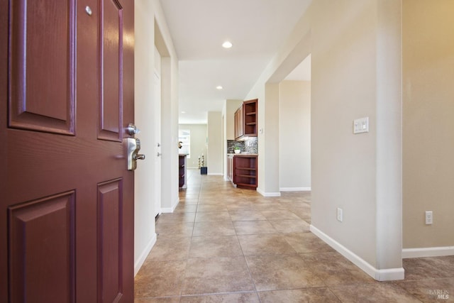 entryway featuring light tile patterned flooring, recessed lighting, and baseboards