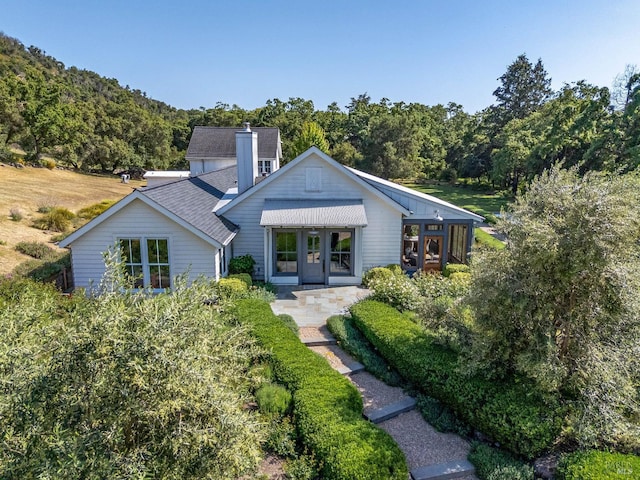 5310 Silverado Trl, Napa, CA 94558 - back of house featuring roof with shingles, a view of trees, and a chimney