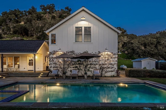 5310 Silverado Trl, Napa, CA 94558 - back of property with board and batten siding, an outbuilding, an outdoor pool, a patio area, and a storage unit
