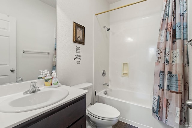 full bathroom featuring wood finished floors, shower / bath combination with curtain, toilet, and vanity