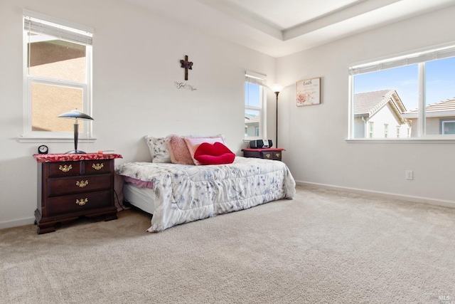 carpeted bedroom featuring baseboards