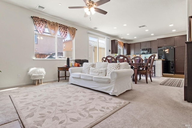 living room featuring visible vents, a ceiling fan, light carpet, and recessed lighting