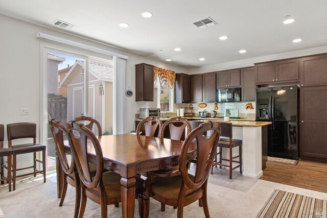 dining area featuring visible vents, light carpet, a toaster, and recessed lighting