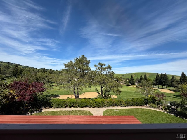 view of home's community featuring a mountain view and a lawn