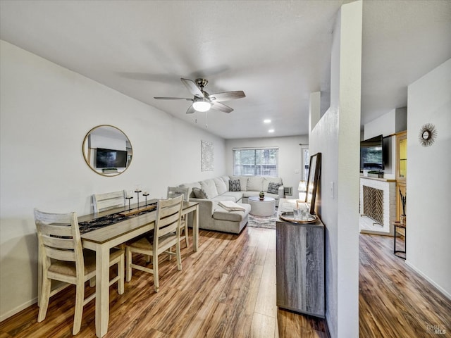 living area with ceiling fan, wood finished floors, and baseboards