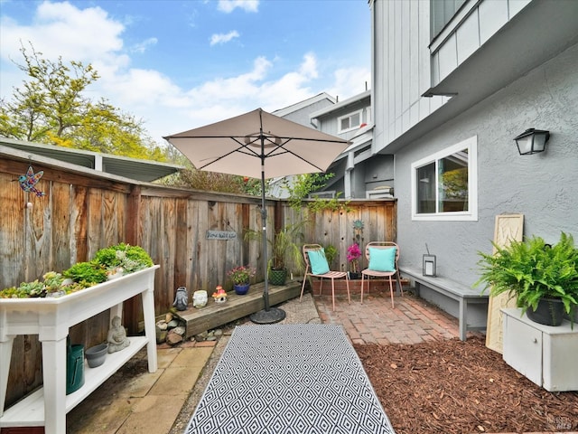 view of patio / terrace featuring fence