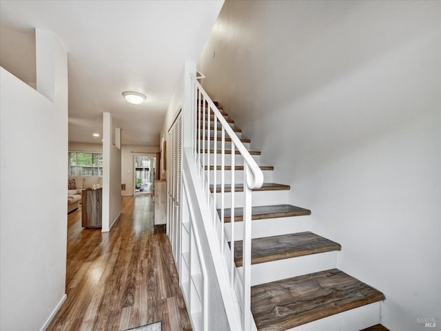 stairway with wood finished floors