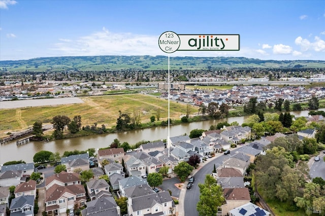 drone / aerial view featuring a residential view and a water view