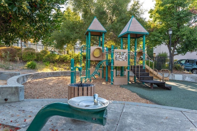 community jungle gym featuring fence