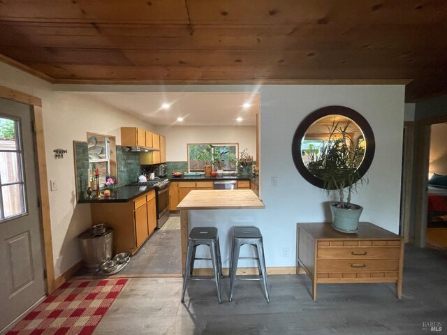 dining space with wooden ceiling, a wealth of natural light, and wood finished floors