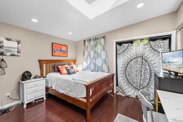 bedroom with recessed lighting, a skylight, and wood finished floors