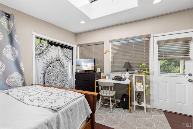 bedroom featuring recessed lighting, wood finished floors, and a skylight