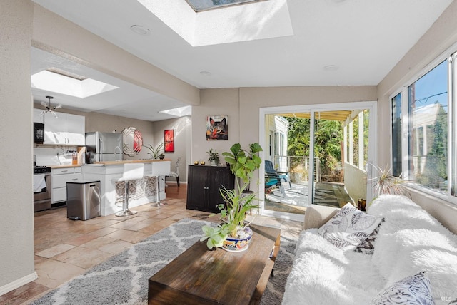 living room with a healthy amount of sunlight and a skylight