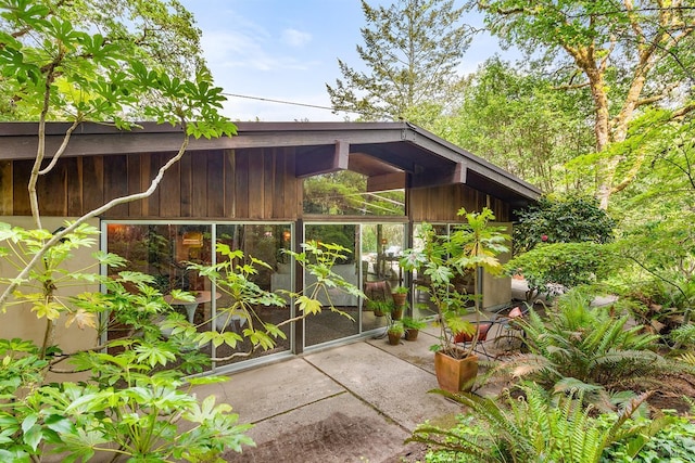 view of outdoor structure featuring a sunroom