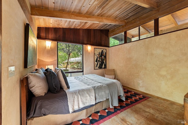 bedroom with lofted ceiling with beams, hardwood / wood-style floors, and wooden ceiling